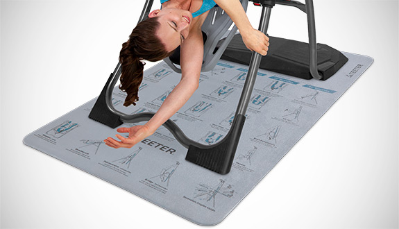 Inverted stretch performed on a Teeter inversion table over the Inversion Program Mat