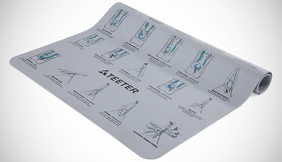 Inversion Program Mat partly rolled up, showing the illustrated movements printed on it